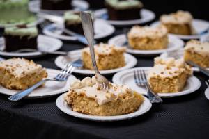 A photo of beautiful slices of plated white cake with white frosting
